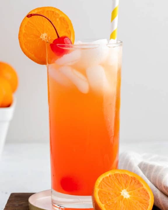 自制的橄榄花园威尼斯日落饮料上装饰着樱桃和橙色片。